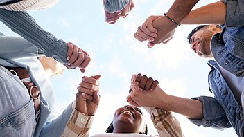 Creative Business Team Stacking Hands In Huddle